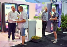 Steef de Lange and Peter van den Ham talking with visitors about their assortment of young plants, tree nursery products and indoor plants, like clematis, pot roses and Amethyst Falls. 